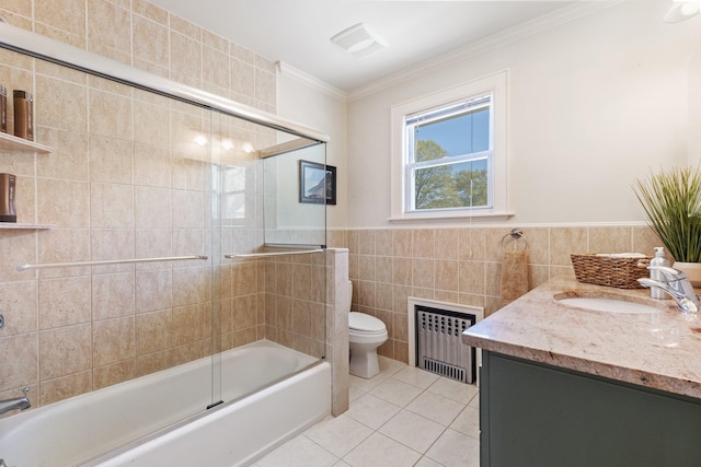 bathroom featuring toilet, tile patterned floors, radiator, tile walls, and ornamental molding