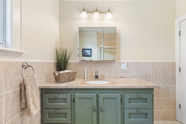 bathroom with tile walls, wainscoting, and vanity