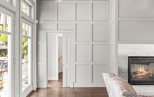 interior space featuring a fireplace, wood finished floors, and a decorative wall