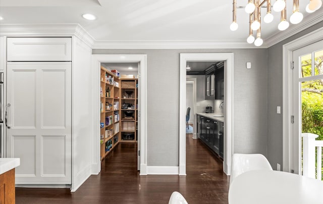 dining room featuring baseboards, ornamental molding, dark wood finished floors, and recessed lighting
