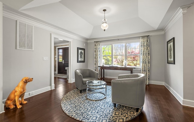 living area featuring baseboards, visible vents, plenty of natural light, and wood finished floors