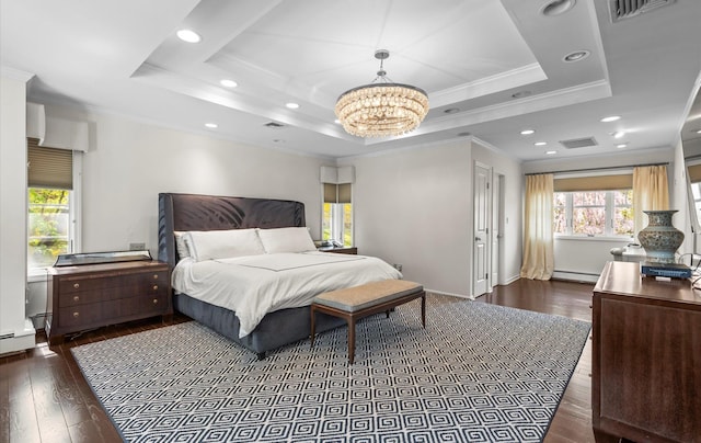 bedroom featuring visible vents, crown molding, a tray ceiling, and baseboard heating