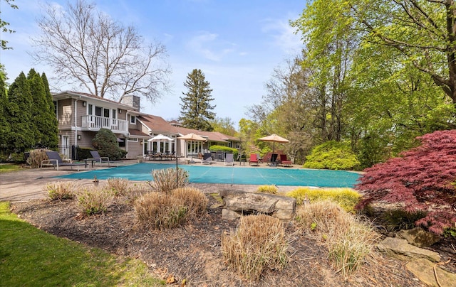 view of swimming pool featuring a patio area and a covered pool