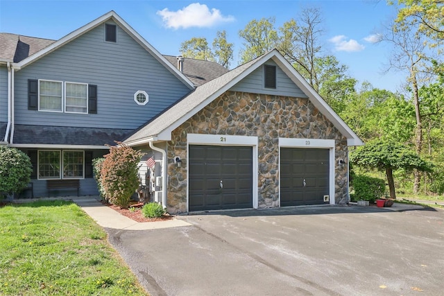21 Lamplight St, Beacon, NY 12508 - traditional home with roof with shingles, an attached garage, driveway, and stone siding
