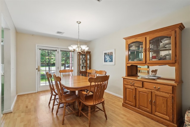 21 Lamplight St, Beacon, NY 12508 - dining area with light wood-style floors, baseboards, and an inviting chandelier