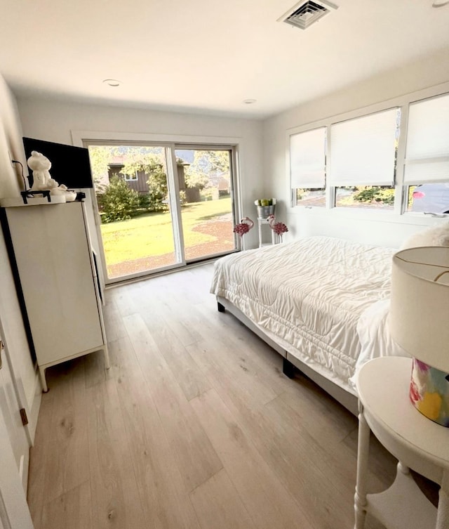 bedroom with access to outside, recessed lighting, light wood-style flooring, and visible vents