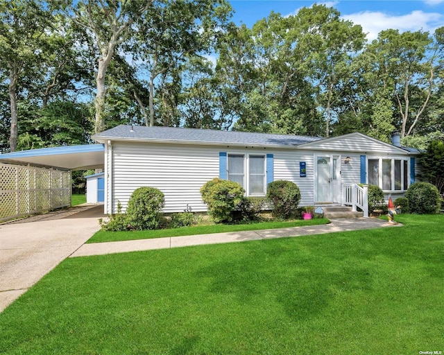 1407-54 Middle Rd Unit 54, Calverton, NY 11933 - manufactured / mobile home with a shingled roof, an attached carport, driveway, and a front lawn