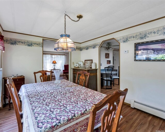 1407-54 Middle Rd Unit 54, Calverton, NY 11933 - dining room with ceiling fan, crown molding, baseboard heating, wood finished floors, and baseboards