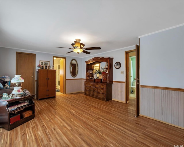 1407-54 Middle Rd Unit 54, Calverton, NY 11933 - living area featuring ornamental molding, a ceiling fan, wainscoting, and light wood-style flooring