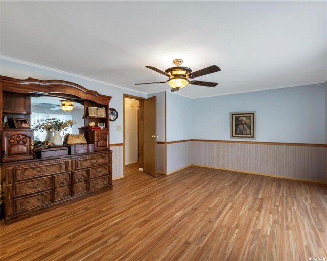 1407-54 Middle Rd Unit 54, Calverton, NY 11933 - empty room with crown molding, a ceiling fan, wainscoting, and wood finished floors