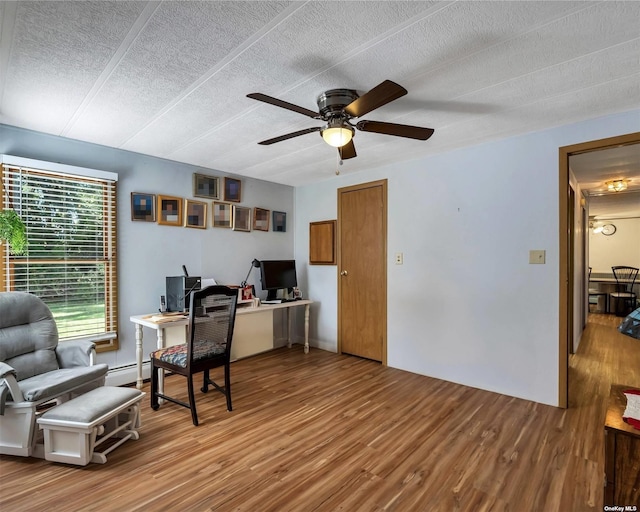 1407-54 Middle Rd Unit 54, Calverton, NY 11933 - office space with a baseboard heating unit, a textured ceiling, ceiling fan, and wood finished floors