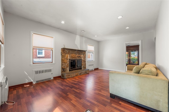 living room with radiator heating unit, recessed lighting, and wood finished floors