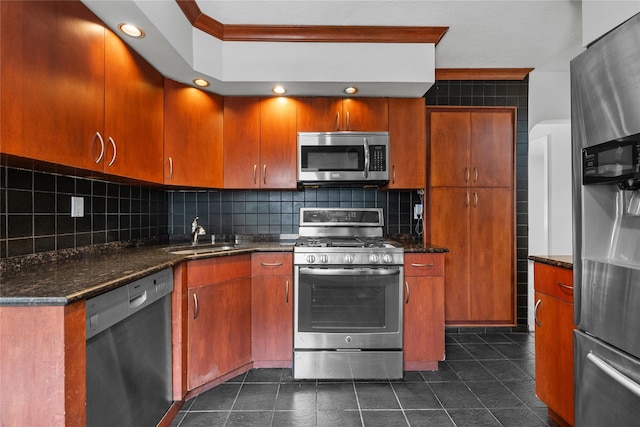 kitchen featuring decorative backsplash, ornamental molding, dark stone counters, a sink, and stainless steel appliances