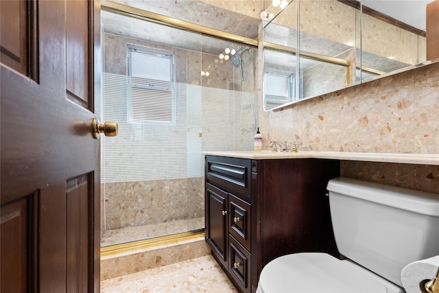 bathroom featuring toilet, a tile shower, and vanity
