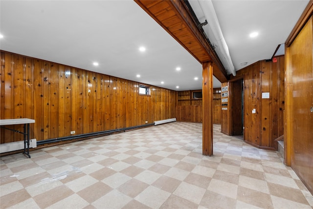 below grade area with stairway, a baseboard radiator, wooden walls, light floors, and recessed lighting