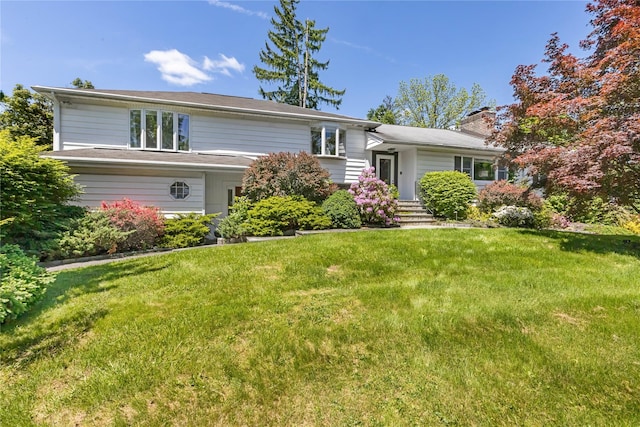 2307 Hawthorne Dr, Yorktown Heights, NY 10598 - tri-level home with a front yard and a chimney