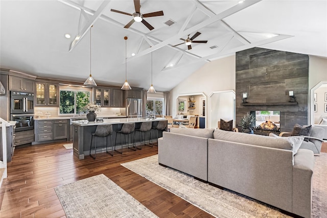 2307 Hawthorne Dr, Yorktown Heights, NY 10598 - living area with ceiling fan, high vaulted ceiling, hardwood / wood-style flooring, a multi sided fireplace, and beam ceiling