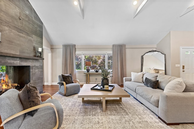 2307 Hawthorne Dr, Yorktown Heights, NY 10598 - living area with vaulted ceiling, a tile fireplace, and wood finished floors