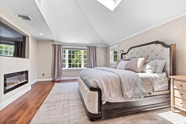 2307 Hawthorne Dr, Yorktown Heights, NY 10598 - bedroom with wood finished floors, lofted ceiling, baseboards, crown molding, and a glass covered fireplace