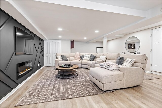 2307 Hawthorne Dr, Yorktown Heights, NY 10598 - living room with wood finished floors, a glass covered fireplace, recessed lighting, and baseboards