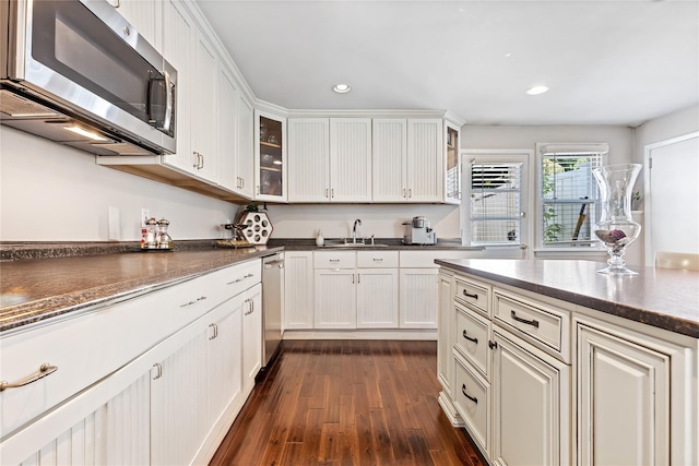 2307 Hawthorne Dr, Yorktown Heights, NY 10598 - kitchen with stainless steel appliances, dark wood-style flooring, recessed lighting, a sink, and white cabinets