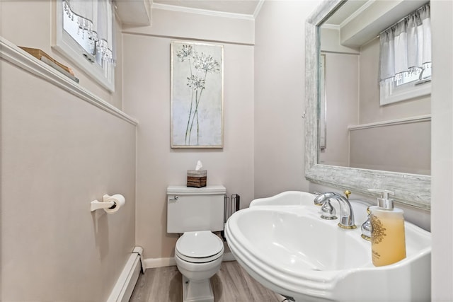 2307 Hawthorne Dr, Yorktown Heights, NY 10598 - half bathroom with crown molding, toilet, wood finished floors, baseboards, and a sink
