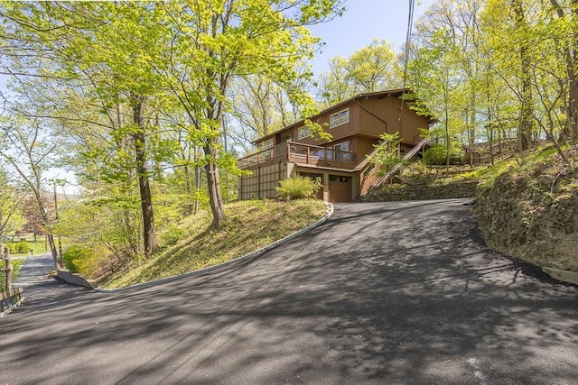 view of front facade with a garage and aphalt driveway