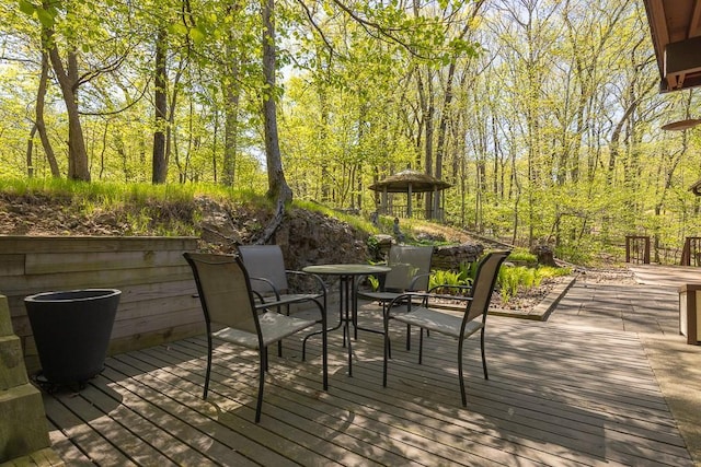 wooden deck featuring outdoor dining space