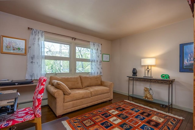 living area featuring baseboards and wood finished floors