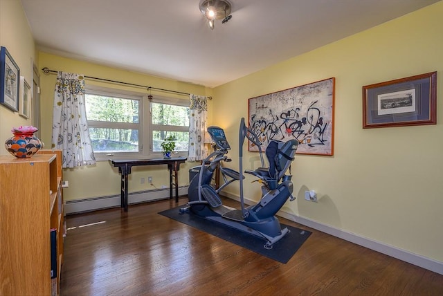 exercise room with baseboards, a baseboard radiator, and wood finished floors