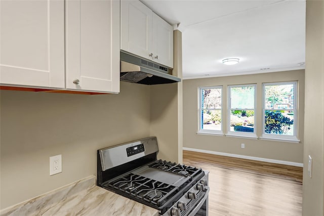 265 Artist Lake Dr, Middle Island, NY 11953 - kitchen featuring white cabinets, baseboards, wood finished floors, gas range, and under cabinet range hood