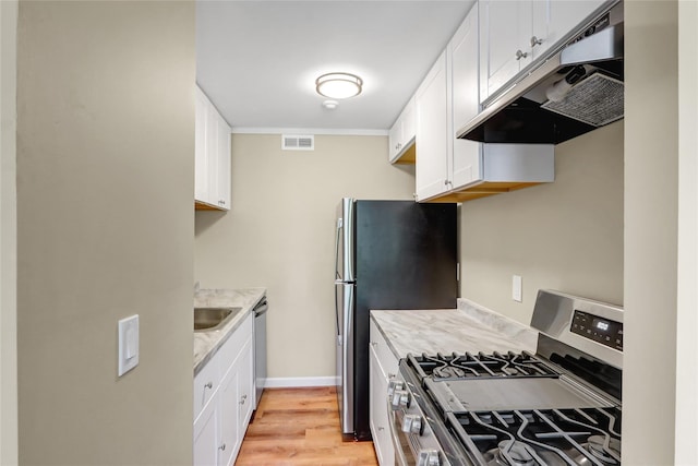 265 Artist Lake Dr, Middle Island, NY 11953 - kitchen with under cabinet range hood, stainless steel appliances, white cabinets, and visible vents