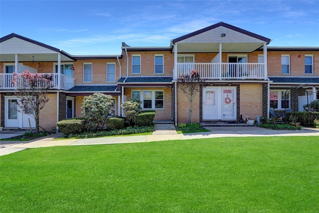 265 Artist Lake Dr, Middle Island, NY 11953 - multi unit property with brick siding, a front lawn, and a balcony