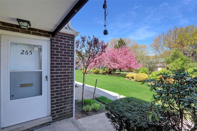 265 Artist Lake Dr, Middle Island, NY 11953 - doorway to property featuring a yard and brick siding