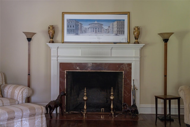 interior details featuring a high end fireplace, baseboards, and wood finished floors