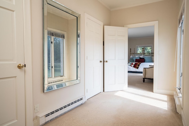 corridor featuring baseboards, ornamental molding, baseboard heating, and carpet flooring