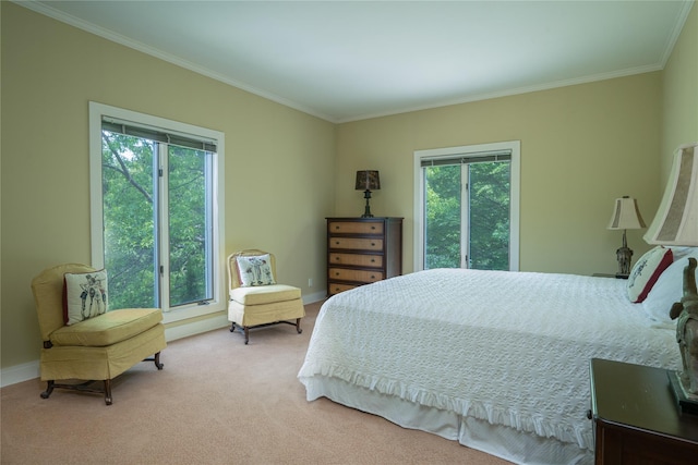 carpeted bedroom with baseboards, ornamental molding, and multiple windows