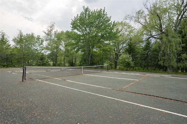 view of tennis court featuring fence