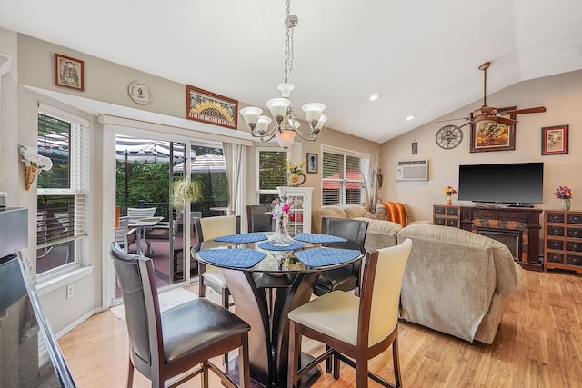 138 Barton Ave, Patchogue, NY 11772 - dining room featuring light wood-style floors, lofted ceiling, a chandelier, ceiling fan, and a wall unit AC