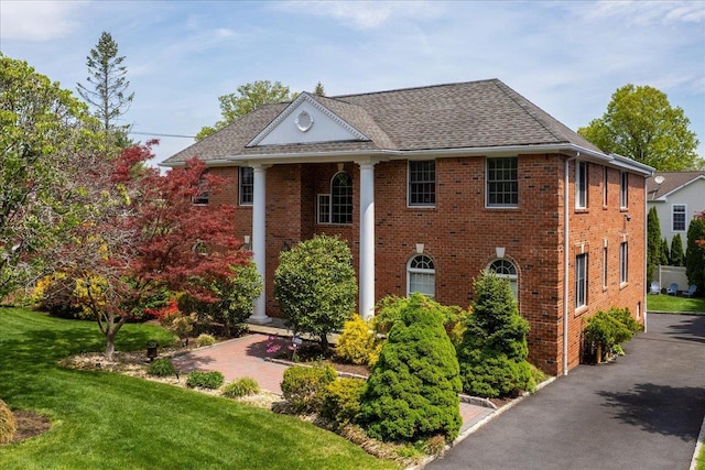 1 Dalessio Ct, Scarsdale, NY 10583 - view of front of property with roof with shingles, a front lawn, and brick siding
