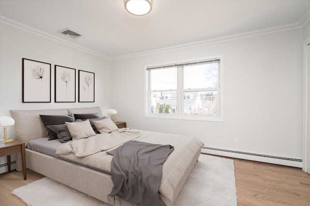 bedroom with visible vents, ornamental molding, light wood finished floors, and a baseboard radiator