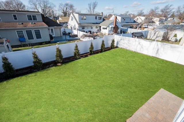 view of yard featuring a residential view and a fenced backyard