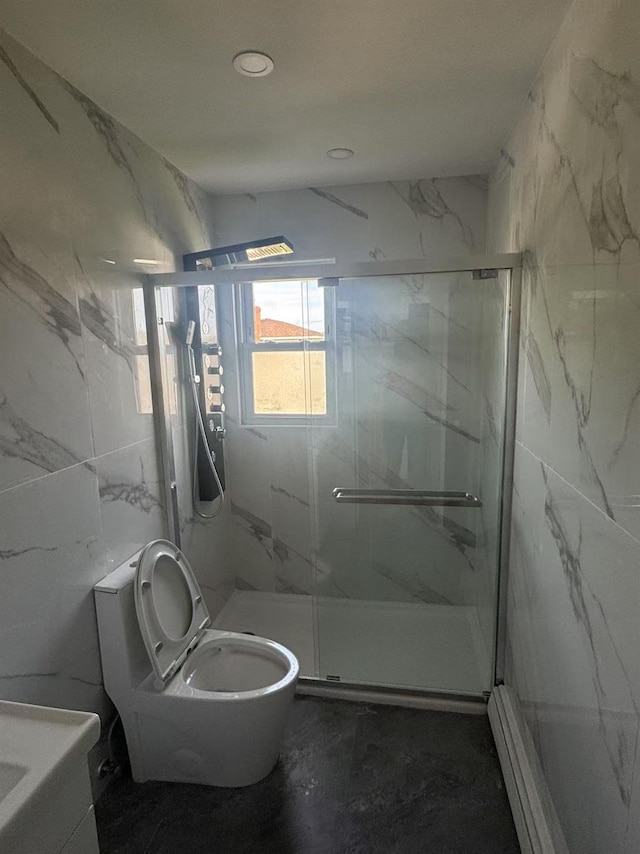 full bath with tile walls, toilet, and a marble finish shower