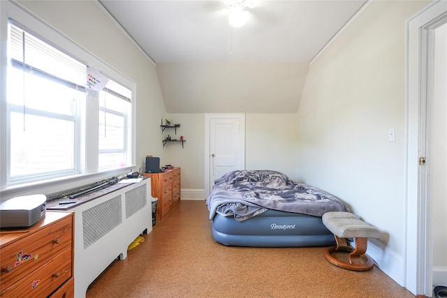 bedroom featuring baseboards, a ceiling fan, and lofted ceiling