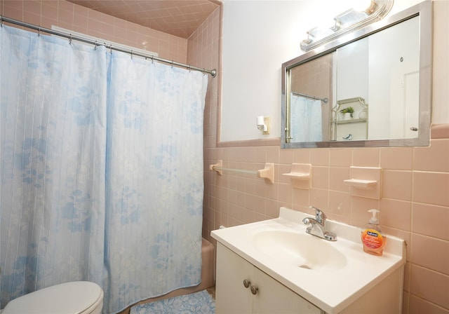 bathroom featuring toilet, tile walls, shower / bath combination with curtain, and vanity