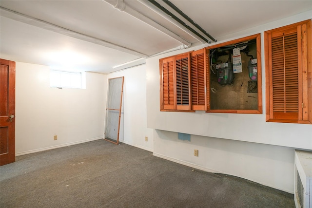 carpeted spare room featuring baseboards