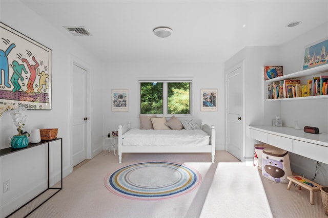 bedroom with visible vents and carpet