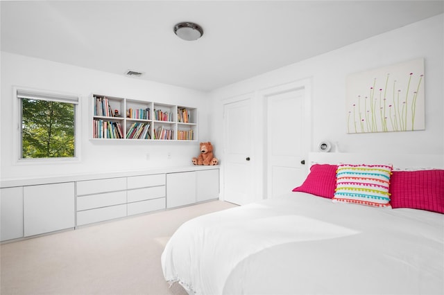 bedroom with light colored carpet and visible vents