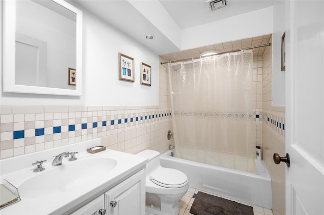 full bath featuring visible vents, tile walls, shower / tub combo, vanity, and toilet