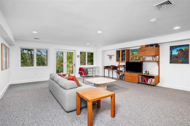 carpeted living area with visible vents, recessed lighting, baseboards, and a healthy amount of sunlight